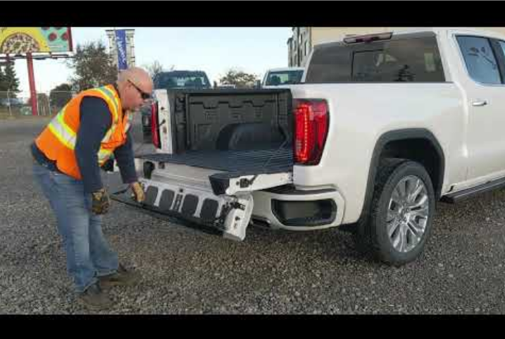 truck opening the door of a pick up truck bed