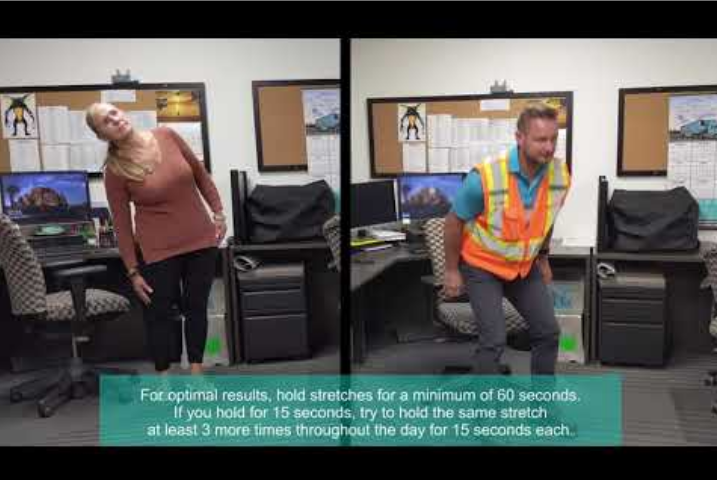 Office workers standing up and stretching by their desks