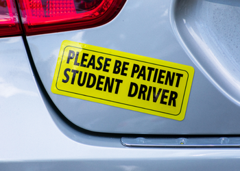 Student driver bumper sticker on silver car